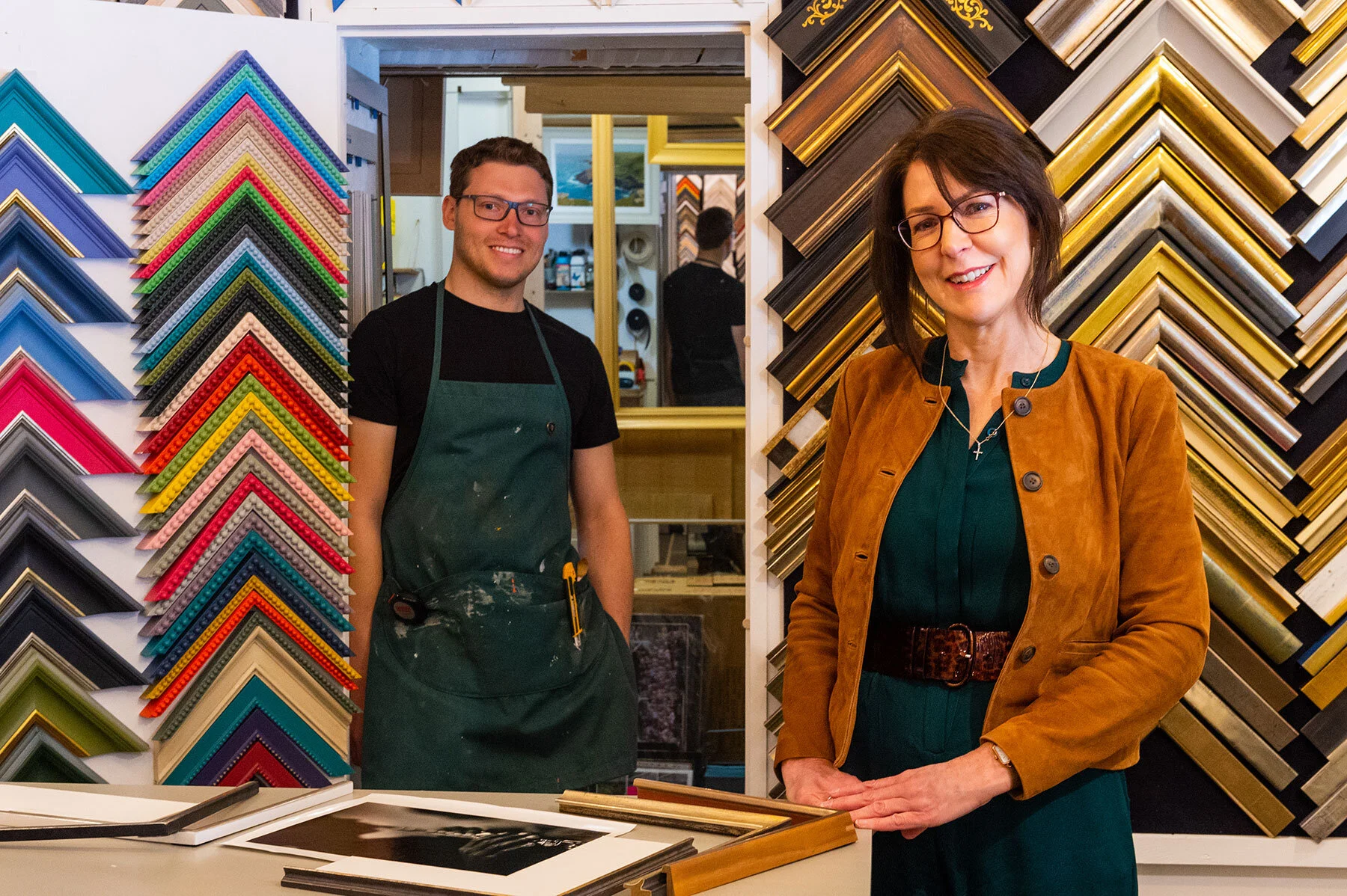 Sarah and Elliot Dunford in the studio against a wall of moulding corner-samples