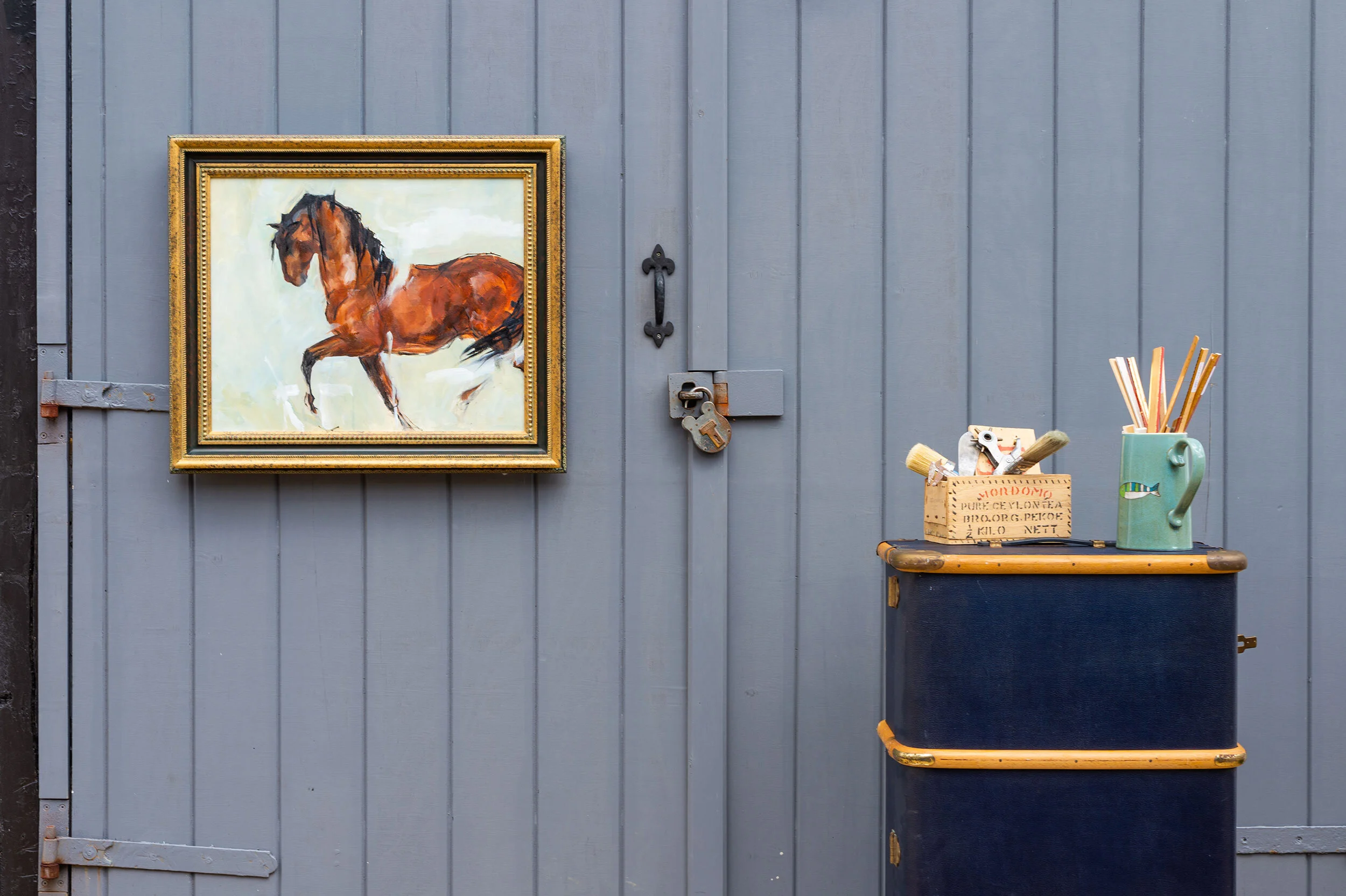 A bay horse in a hand-finished ornate gilt frame.