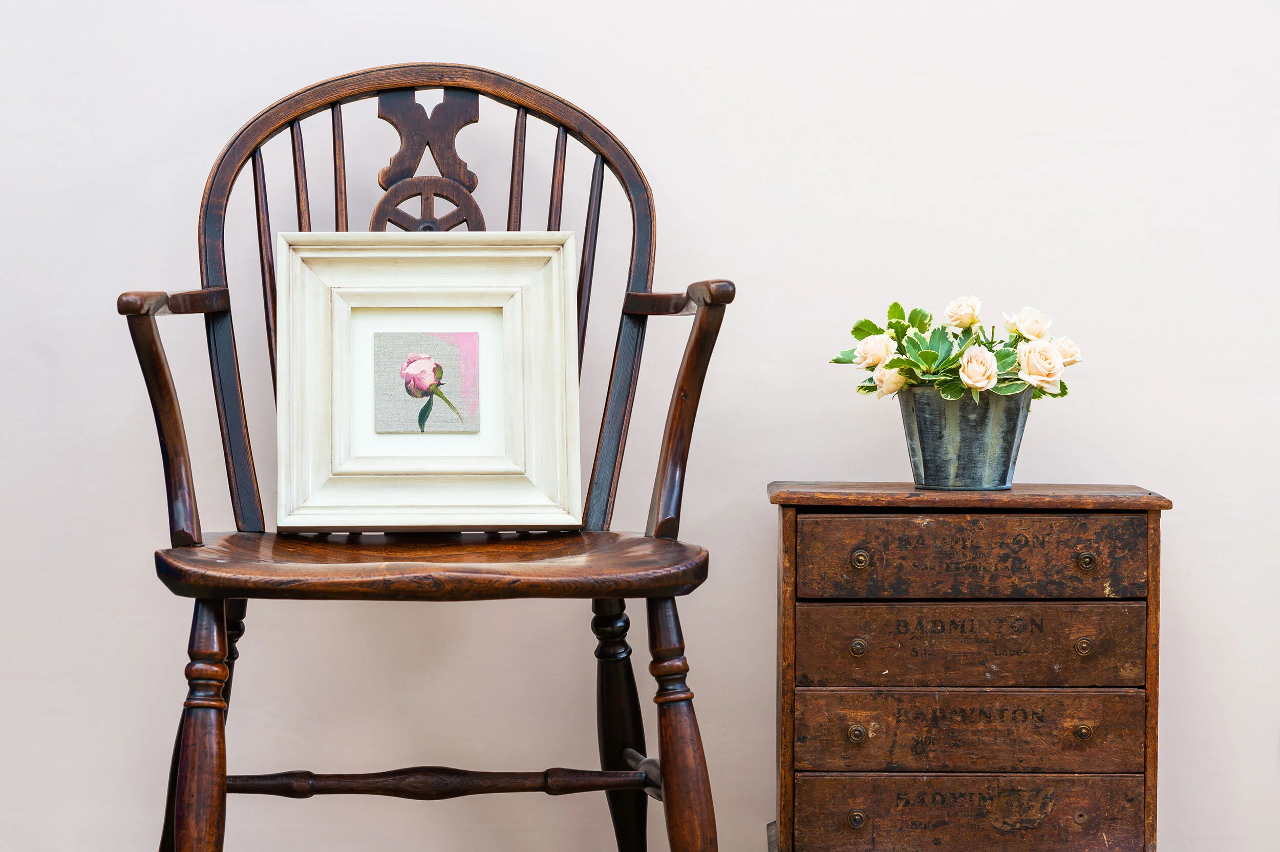 A single rose float-mounted in a cream box frame.
